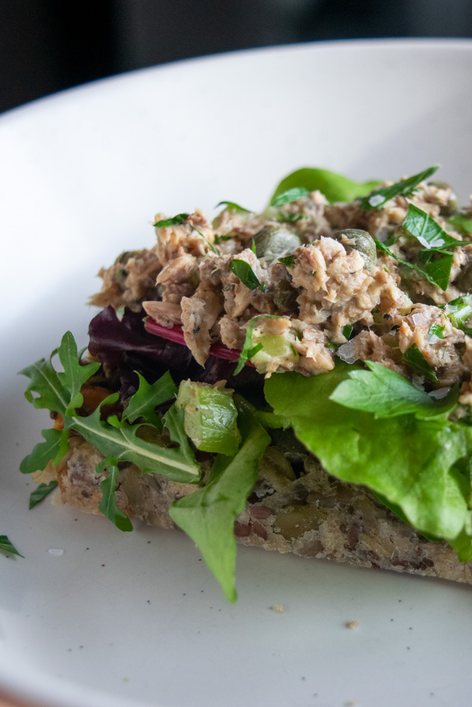 Seedy bread topped with fresh lettuce and sardine salad.