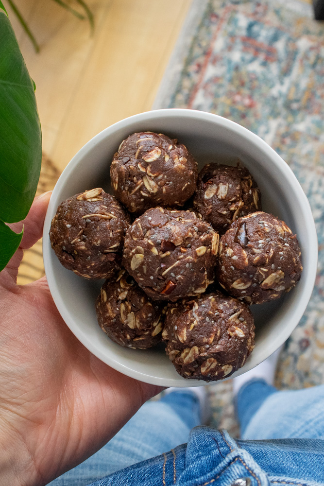 a bowl of chocolate tahini energy balls.