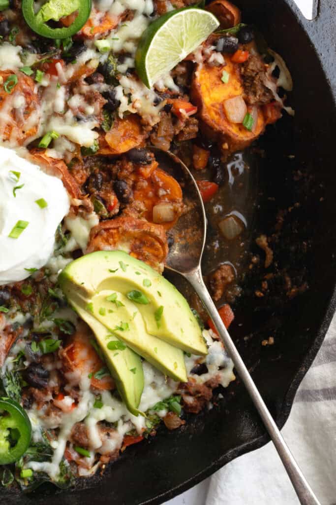 beef and sweet potato taco skillet with a spoon.