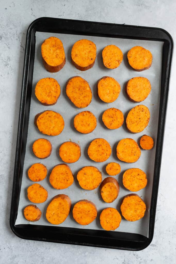a baking sheet with sweet potato slices.