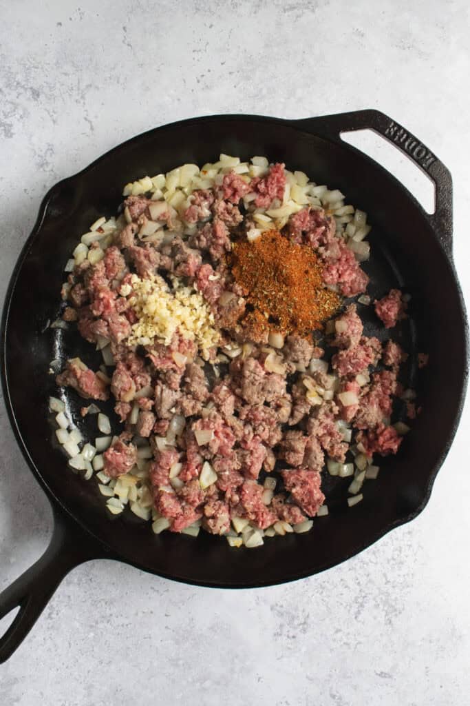 onions, ground beef, minced garlic and spices in a cast iron skillet.