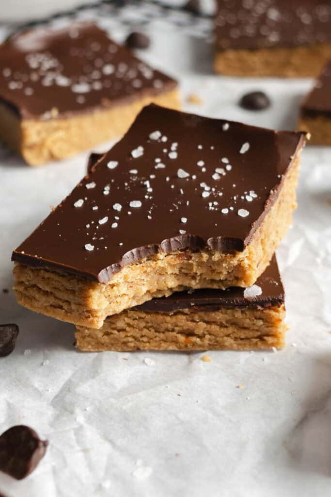 a stack of chocolate protein peanut butter bars.