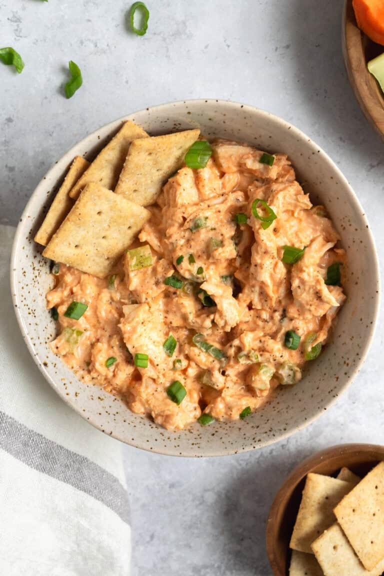 a bowl of buffalo chicken salad with crackers.