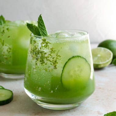 a glass of cucumber apple cider vinegar mocktail with fresh mint.