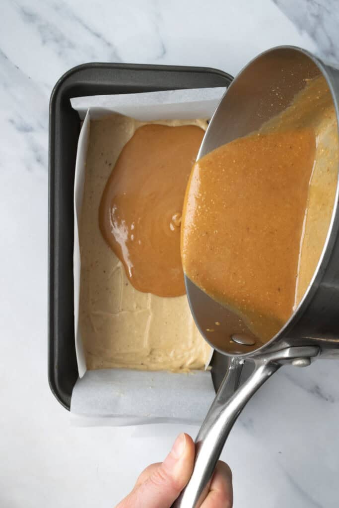 pouring peanut butter caramel over the banana ice cream.