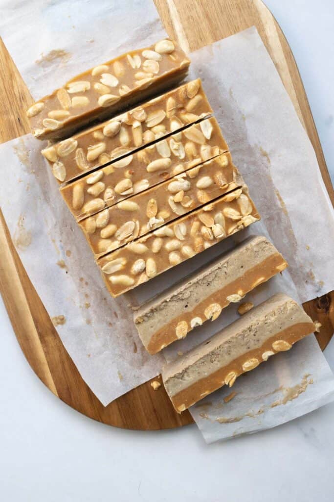 ice cream bars sliced on a cutting board.