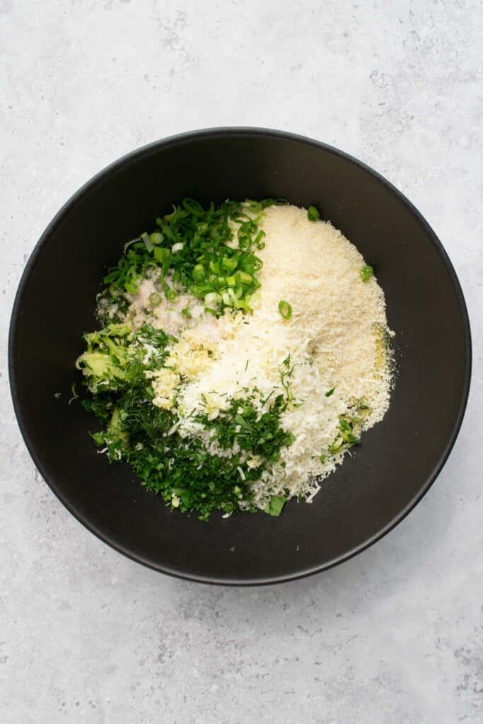 zucchini bites ingredients in a large black bowl.