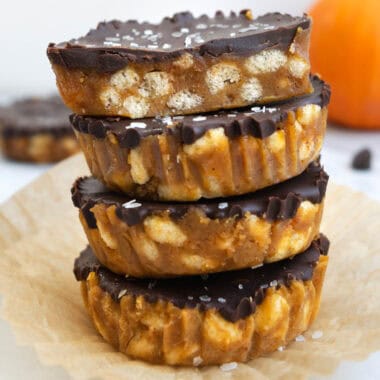 stacked crunch cups in front of an orange pumpkin.