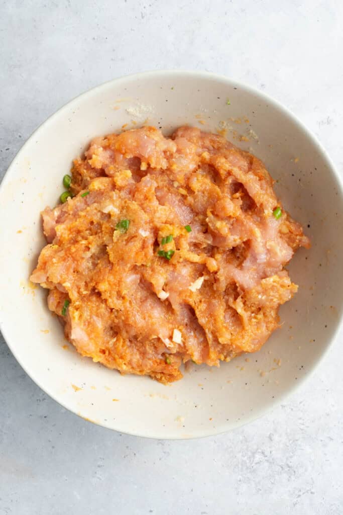 meatball mixture in a white bowl.