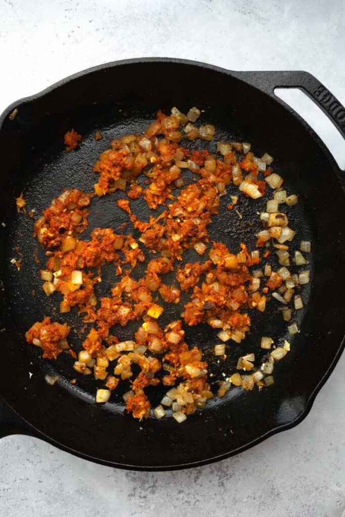 onion, garlic, ginger and red curry paste in a skillet.