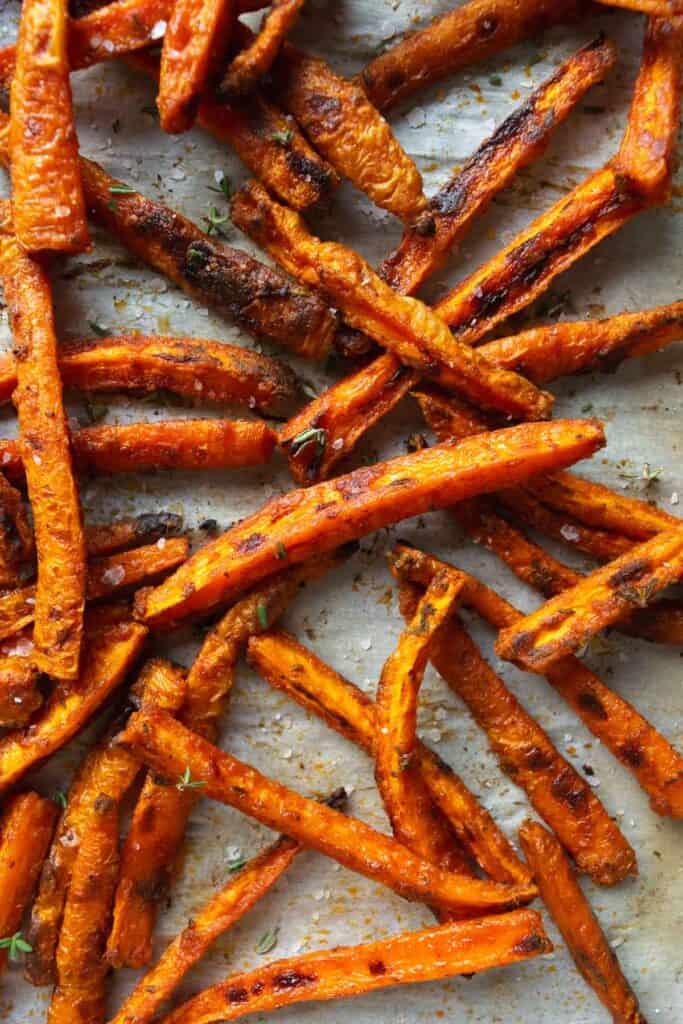 baked carrot fries on a baking sheet.