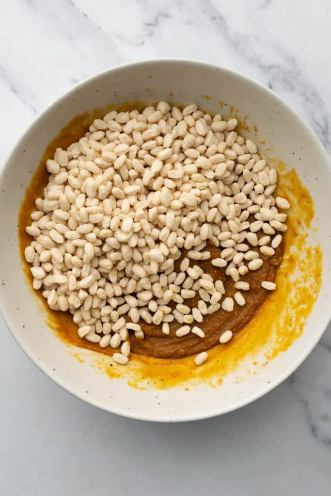 crunch cup base in a white bowl topped with rice crisp cereal.