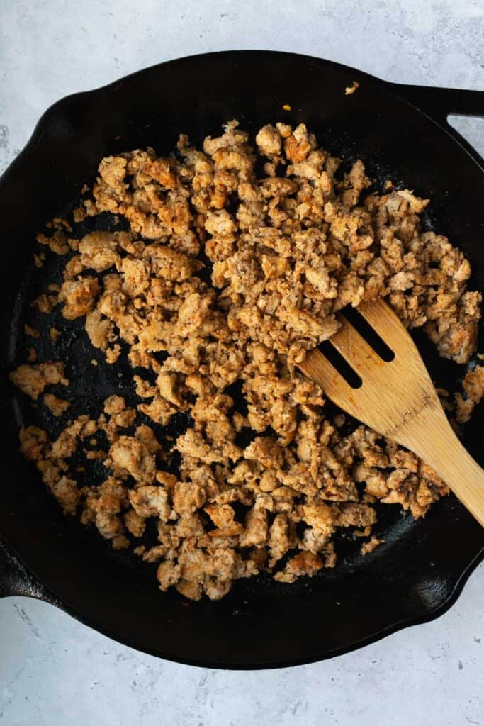 cooked ground chicken in a cast iron skillet