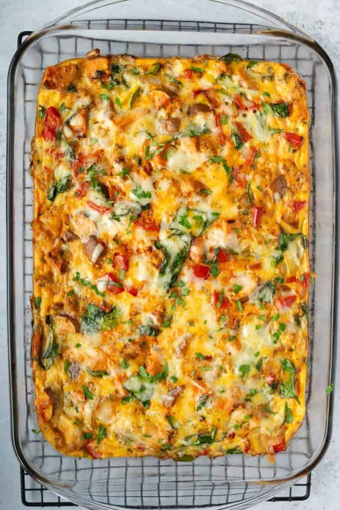 cooked breakfast casserole in a glass dish on a cooling rack