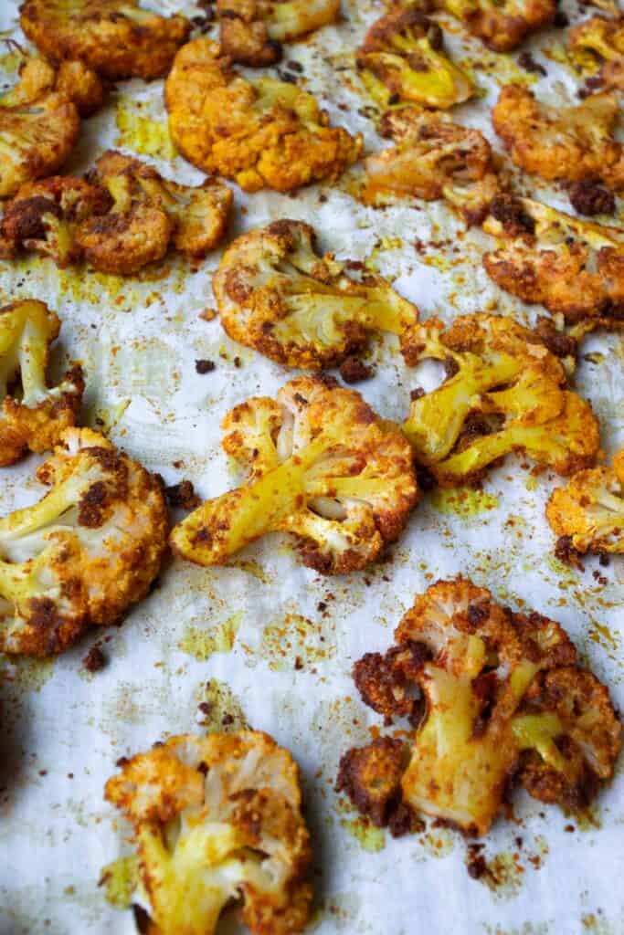 smashed roasted cauliflower on a sheet pan.