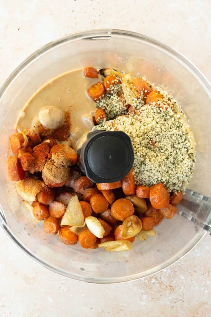 roasted carrot dip ingredients in the bowl of a food processor